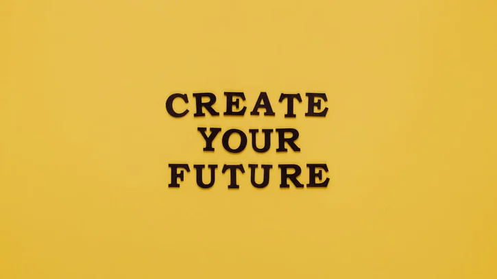 Bold text 'CREATE YOUR FUTURE' on minimalist yellow background. Inspiring design.