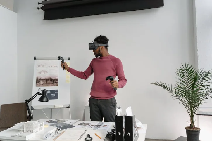 Young architect explores designs using VR technology in a stylish office setting.