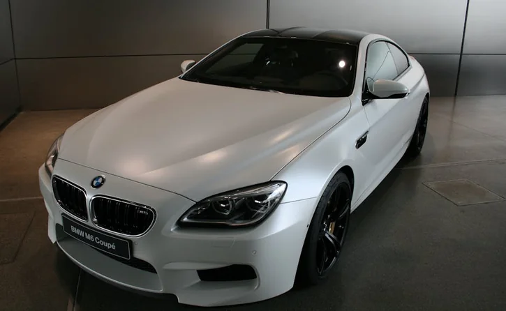 Sleek BMW M6 Coupé in a showroom highlighting luxury and performance.