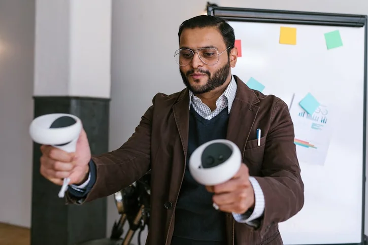 Man in business attire using VR controllers during an office meeting.