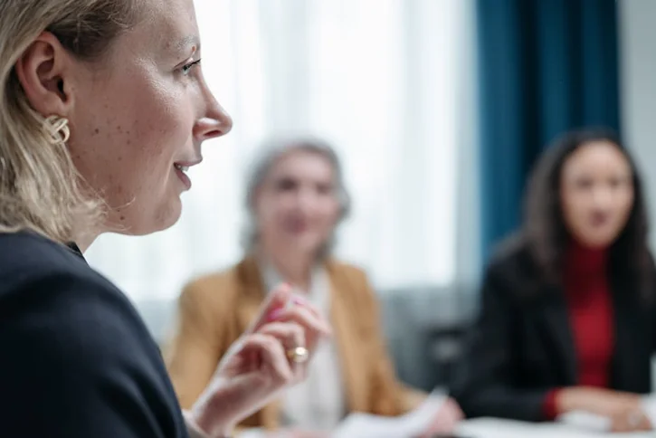 Close-up of women involved in a professional business meeting indoors.